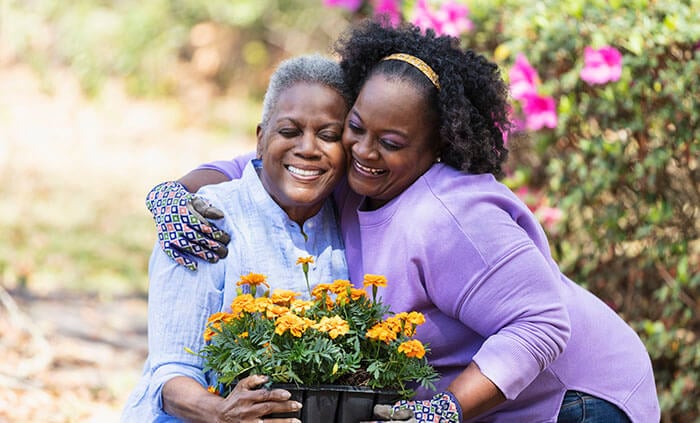 People hugging in a garden